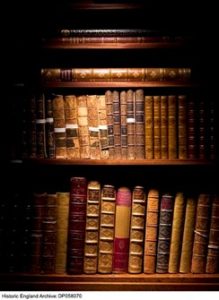 Old leather bound books on shelves